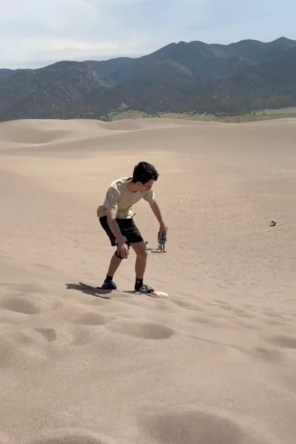 Maceo sandboarding at Great Sand Dunes, Colorado